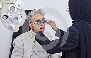 Eye exam, glasses and senior woman with optometrist in clinic for testing eyes, check eyesight and optical care. Vision