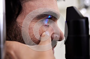 Eye exam, vision or laser test for patient with machine at optometry consultation for retina problem. Hands, eyesight or