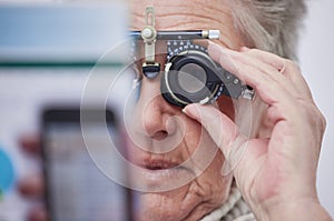 Eye exam, vision and senior woman with lens in clinic for testing eyes, eyesight and optical assessment. Optometry