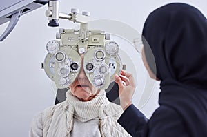 Eye exam, vision and senior woman with optometrist in clinic for testing eyes, check eyesight and optical care