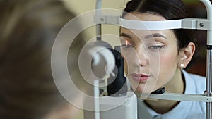 Eye examination at slit lamp in oculist office