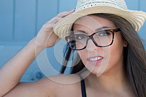 eye glasses on beautiful woman outside portrait with straw hat optometrist make-up head shot