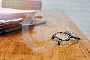 Eye glasses and documents on office desk
