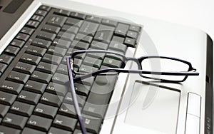 Eye glasses on laptop