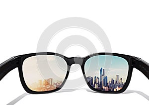 Eye glasses looking to city view, focused on glasses lens photo