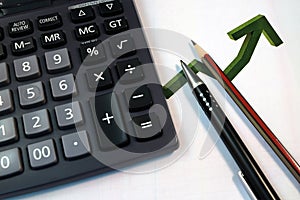 Eye Glasses, pen and pencil over the Formula with calculator