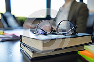 eye glasses placed on the desk are eye glasses that are prepared for people with farsightedness to work and read documents clearly