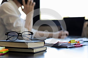 eye glasses placed on the desk are eye glasses that are prepared for people with farsightedness to work and read documents clearly