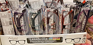 Eye glasses on window display shelves in optics store