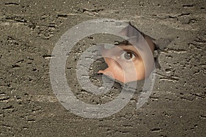 Eye looking through a hole in wall.