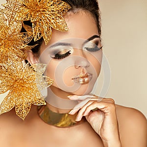 Eye Makeup. Beautiful Girl With Golden Flowers. Beauty Model Woman Face. Perfect Skin. Professional Make-up. Fashion Art Photo