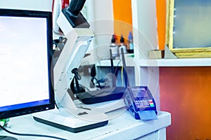 Eye measuring equipment and credit card reader machines in eyeglass stores