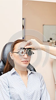 Eye ophthalmologist exam. Eyesight recovery. Astigmatism check concept. Ophthalmology diagmostic device. Beauty girl portrait in