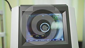 eye on the screen of the autorefractometer. a modern ophthalmic device.