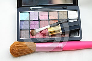 Eye shadow palet with lipstick and brush