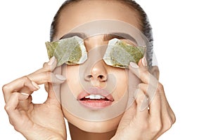 Eye Skin Care. Beautiful Woman With Green Tea Bag Under Eyes