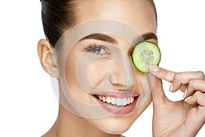 Eye Skin Care. Woman With Natural Makeup Using Cucumber