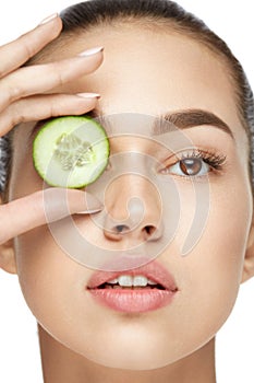 Eye Skin Care. Woman With Natural Makeup Using Cucumber