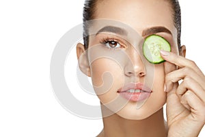 Eye Skin Care. Woman With Natural Makeup Using Cucumber