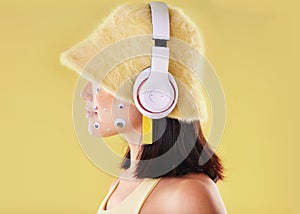 Eye stickers, music headphones and woman in studio isolated on a yellow background mockup. Funny, technology and face