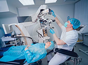 Eye surgery. A patient and surgeon in the operating room