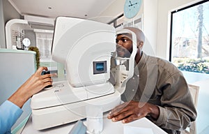 Eye test, exam or screening with a young man at the optometrist using an automated refractor. Patient testing his vision