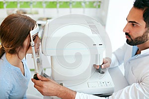 Eye Test. Optometrist Testing Woman Eyesight On Modern Equipment