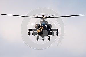 Looking at the front of a hovering Apache Longbow helicopter photo