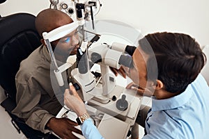 Eye, vision or sight test or exam of a patient above at an optometrist, optician or ophthalmologist. Testing and