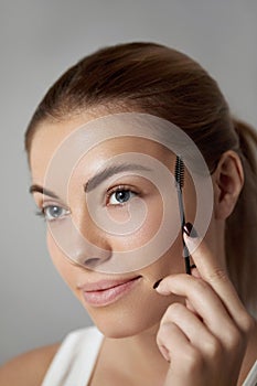 Eyebrow Care. Closeup Of Beautiful Woman Model With Eyebrow Brush