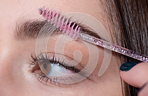 Eyebrow makeup. Macro close up of brows. Beauty model shaping brows with brow pencil closeup. Beautiful woman contouring