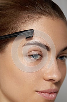 Eyebrows Care. Young Female Model Shaping Brown Eyebrows.