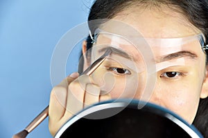 Eyebrows shaping makeup template, Asian women filling eyebrows to look thicker.