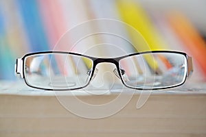 Eyeglass on book