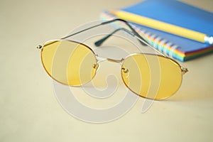 eyeglass, notepad and newspaper on table . photo