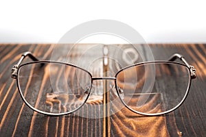 Eyeglasses with bifocals lenses on wooden board