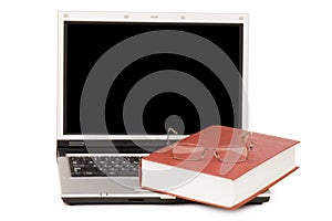 Eyeglasses and books on the laptop