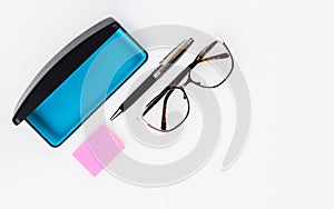 Eyeglasses with case and pen and paper.