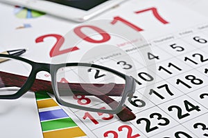 Eyeglasses, charts and 2017 calendar