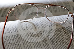 Eyeglasses on a dictionary