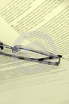 Eyeglasses on a document closeup