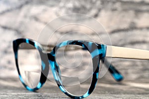 Eyeglasses Glasses with Bifocals and Black Blue Frame Fashion Vintage Style on Wood Desk Background, Rustic Still Life Style