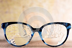 Eyeglasses Glasses with Bifocals and Black blue Frame smudged agaist written letters.  Blurry Vision Concept