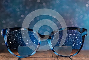 Eyeglasses Glasses with Bifocals and Black blue Frame smudged view agaist a starry night sky. Blurry Vision Concept