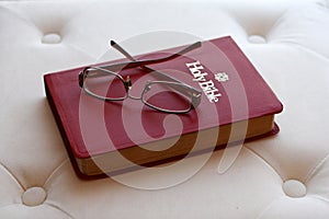 Eyeglasses on Holy Bible with backlighting