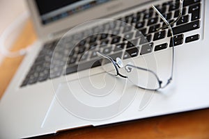 Eyeglasses on laptop keyboard