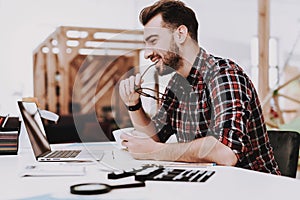 Eyeglasses. Laptop Screen. Cup of Coffee. Desk