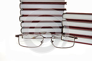 Eyeglasses laying about books