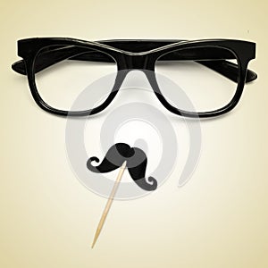 Eyeglasses and moustache as a hipster guy, with a retro effect