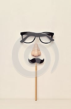 Eyeglasses, nose and mustache depicting a man face